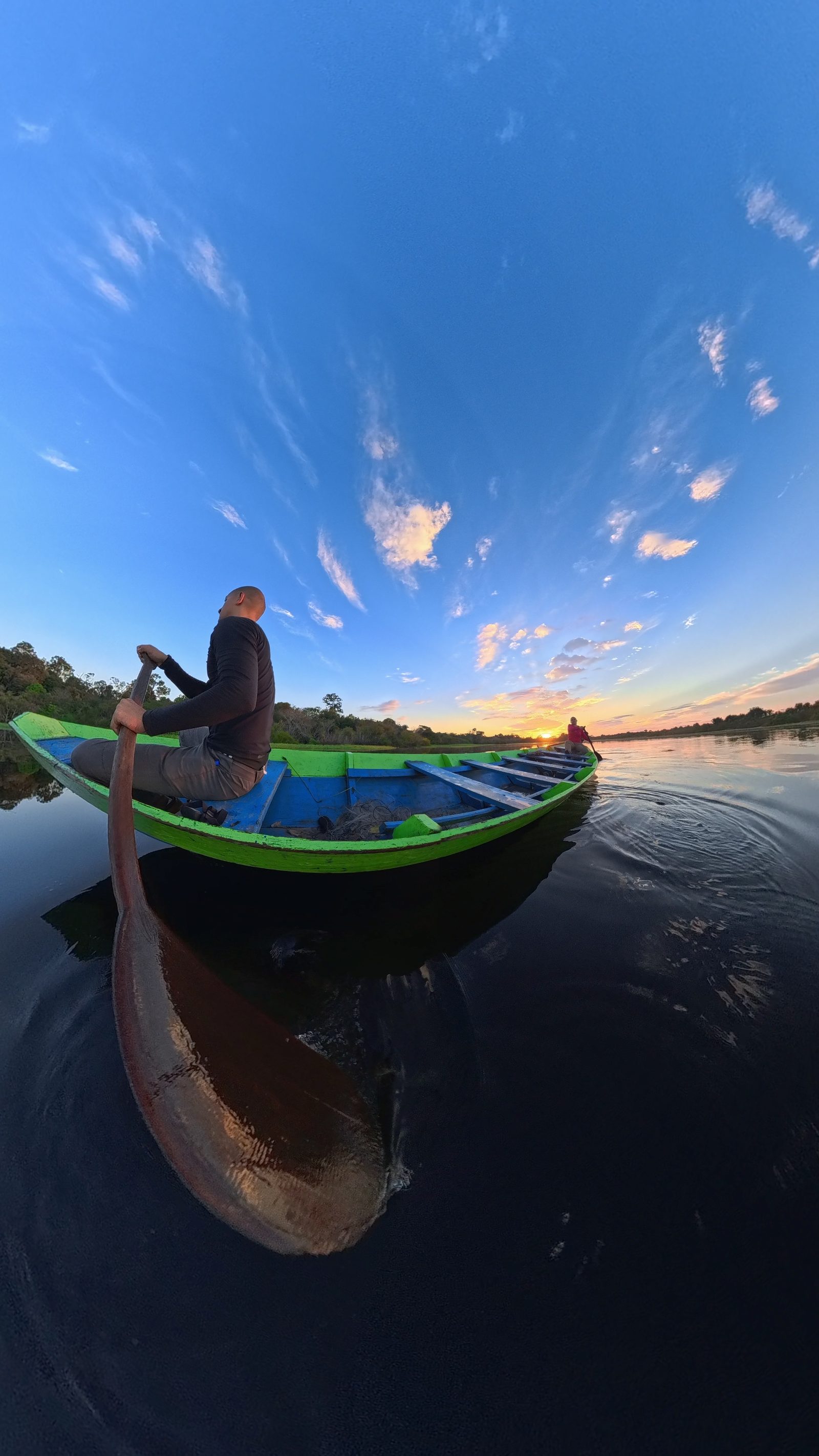 Canoe on the Amazon river at sunset, the ultimate expedition